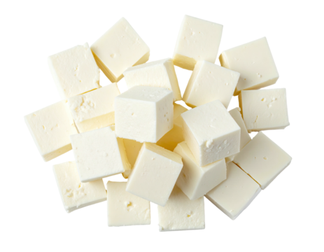 Overhead shot of creamy, soft, square cut cheese cubes arranged against a black background