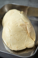 Close-up View of a Large, Fresh Raw Slice of Foie Gras (Goose or Duck Liver), Highlighted as a Premium Gourmet Ingredient for French Cuisine