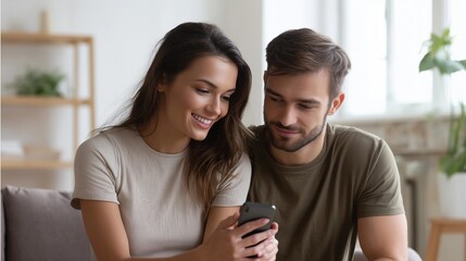 Woman and man sit side by side in modern living room,holding smartphone while smiling,copy space