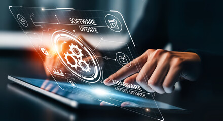 Futuristic holographic interface displaying software update process with gears and icons, a persons hand interacting with the technology