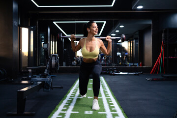 Fitness woman exercising with barbell weights on cross training.