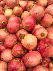 heap of Fresh pomegranates at local farmers market. fruit background