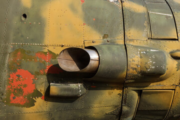 Details of the fuselage of an old aircraft. Old camouflage surface with exfoliated paint and rivets on a military aircraft.