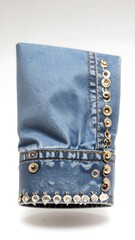 Light blue denim sleeve with gold and silver embellishments