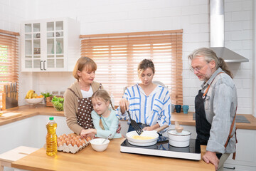 Happy big family prepare cooking for food in kitchen at home. Senior elderly grandparent and their daughter having fun spend leisure time together, making breakfast with happiness in house.