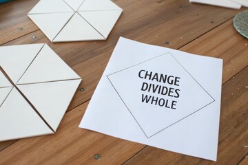 Paper displaying Change Divides Whole with geometric triangle shapes