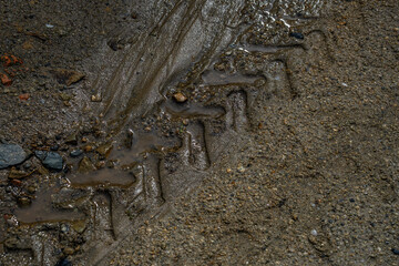 The track from the tractor wheel on the road.