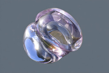 A stunning close-up of an abstract glass sculpture featuring smooth, intertwining forms with a clear and purple tint, set against a subtle grey backdrop.