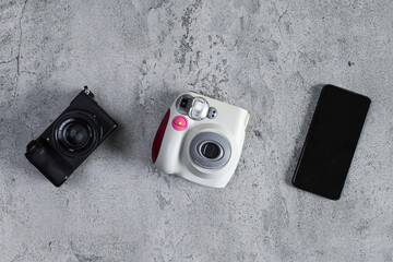 Top View Of Modern Digital Camera, Instant Camera, And Smartphone