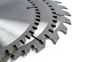 Overlapping circular saw blades showing the carbide-tipped teeth and expansion slots: Emphasizes industrial precision, cutting technology, metal texture, and workshop equipment