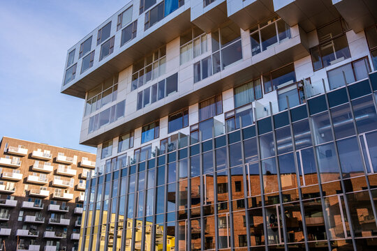 Glass and steel buildings reflecting surrounding district showing mixed use housing offices and design innovation that defines contemporary Scandinavian architecture in Orestad Copenhagen