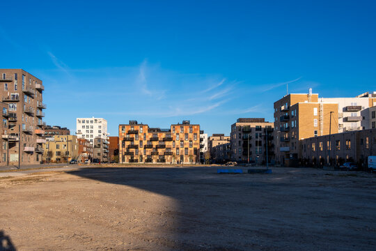 Urban square surrounded by new residential buildings showing open civic space modern design and future oriented planning principles in Orestad Copenhagen