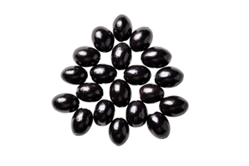 Shiny, dark, almond-shaped candies stacked in a pyramid