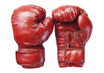 Pair of worn, red leather boxing gloves on a dark backdrop