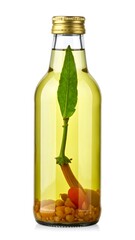 Small glass bottle filled with oil, herbs, and spices