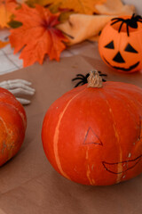 Carving festive Halloween pumpkins at home with family decorations