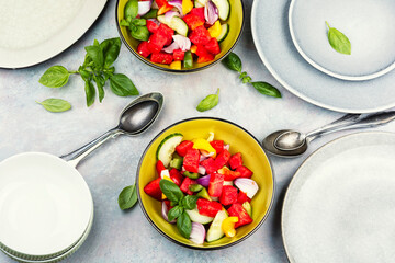 Bowl of salad with watermelon, cucumber.