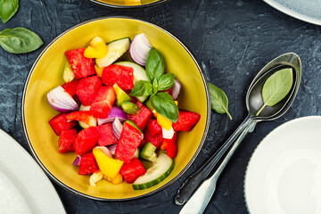 Vegetarian watermelon salad bowl with cucumber.