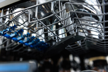 An open dishwasher with clean dishes in the kitchen.