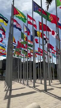 daytime view of square with international flags waving in doha qatar