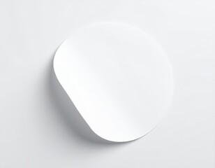 White circle sticker with peeling edge on light surface