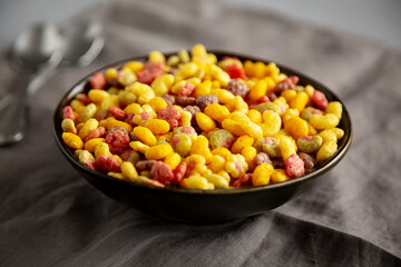 Fruity Kids Breakfast Cereal with Milk in a Bowl, side view.