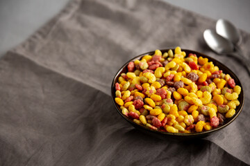 Fruity Kids Breakfast Cereal with Milk in a Bowl, side view. Copy space.