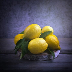Lemons with green leaves. Still life with citrus fruits.