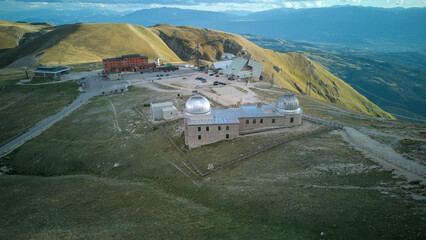 Aerial drone footage of the Astronomical Observatory of Abruzzo at Campo Imperatore, set against majestic mountain landscapes