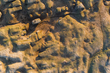 Aerial drone view of a unique limestone karst landscape in Estonia with ancient geological formations and warm evening light.