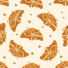 A whimsical pattern of delicious croissants tied with bows and scattered hearts.
