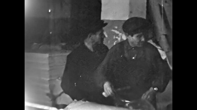 Vintage film, Male factory workers prepare paper roll for production in manufacturing industry. Industrial technology processing. Cardboard material for product. Old archive. Archival retro 1960s