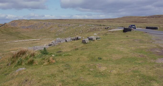 wide shot looking north up Kaber fell, and Bowes moor with a car on the Regional RTE 71 road. At the pennines
