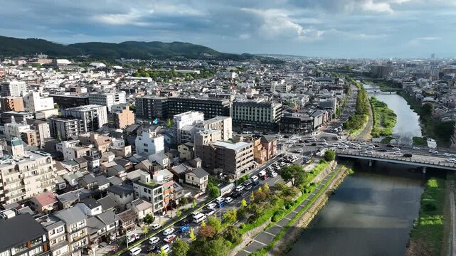 Scenic Aerial View Of Kyoto, Japan In Daytime With View Of Kamo River And Bustling Gojo Bridge.