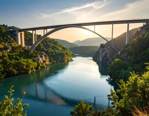 Majestic arch bridge spanning a tranquil river valley at sunset