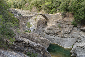 Stone arch bridge in mountains, Alps, Italy