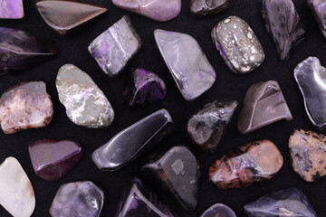 Sugilite rare jewel stones texture on black background