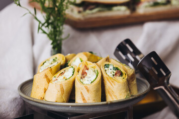 Beautifully decorated banquet catering table, with variety of with different food snacks appetizers on corporate birthday party event or wedding celebration, canape, salad, delicatessen setting