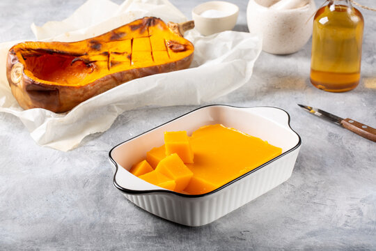 Pumpkin marmalade. Homemade pumpkin jelly candies on white plate on gray background.