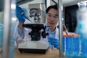 scientist researcher conducting an experiment working in the chemical laboratory.
