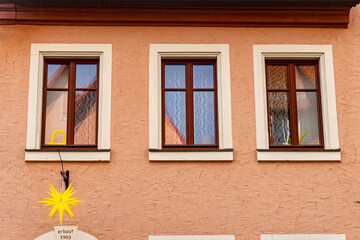 Fototapeta premium Exterior of an old Bavarian house from 1903 decorated with a Christmas star. Traditional German architecture and festive holiday atmosphere.
