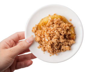 Hand Holding Small White Plate of Apple Crumble Dessert