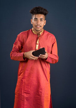 Young handsome man holding and using smartphone or mobile phone
