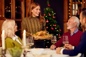 Friendly Waitress Serves Festive Christmas Dinner Platter to Family and Friends