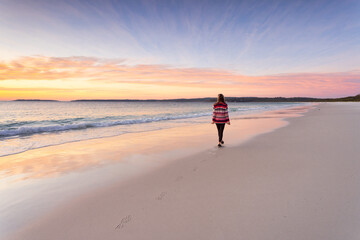 Woman morning walk along the beach sunrise sky