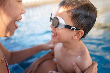 Happy Child And His Mother In Pool Embracing Joyful Connection Together