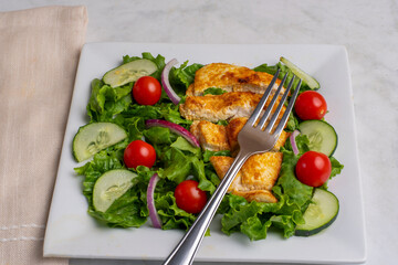 salad top with seasoned  chicken breast