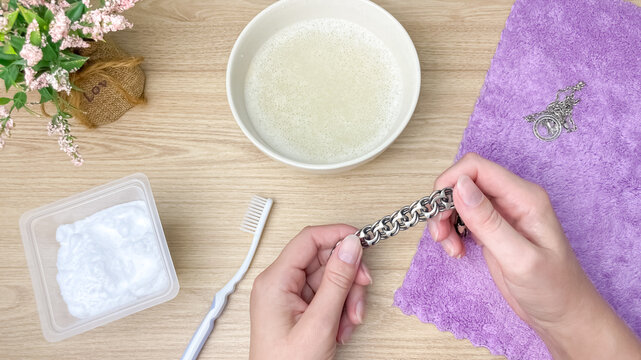 A simple home silver cleaning method using household items: baking soda, water, soap, and a toothbrush. Cleaning silver jewelry without chemicals.