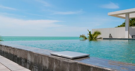Fototapeta premium Remote Laptop Overlooking Tropical Sea Workspace Minimalism