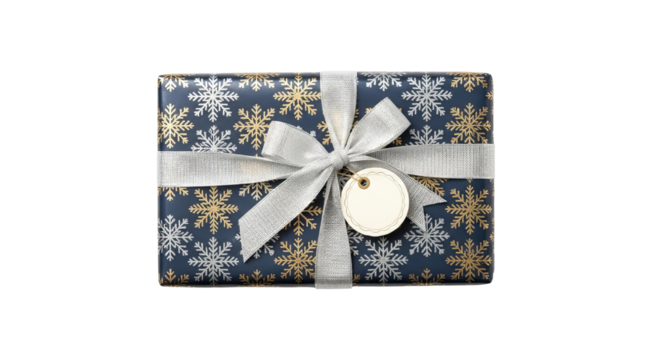 Wrapped gift presents a silver ribbon tied in bow with hanging tag on patterned paper.